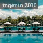 Black Outdoor Lounge Chair in Between Blue Swimming Pool Under White Cloudy Blue Sky